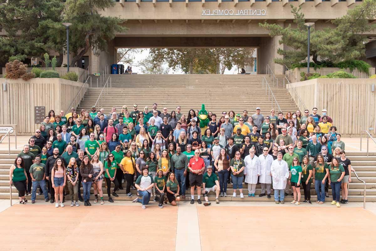 Students, staff, and mascot on large staircase